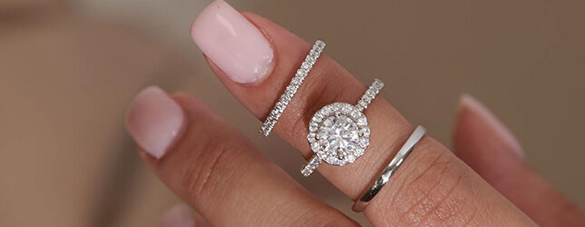 Oval halo diamond engagement ring with pav&eacute; setting and matching gold bands